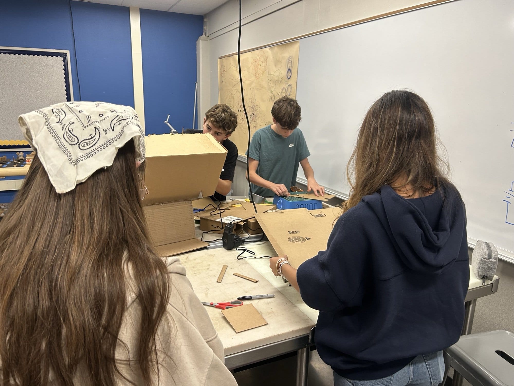 Students building cardboard pinball machines